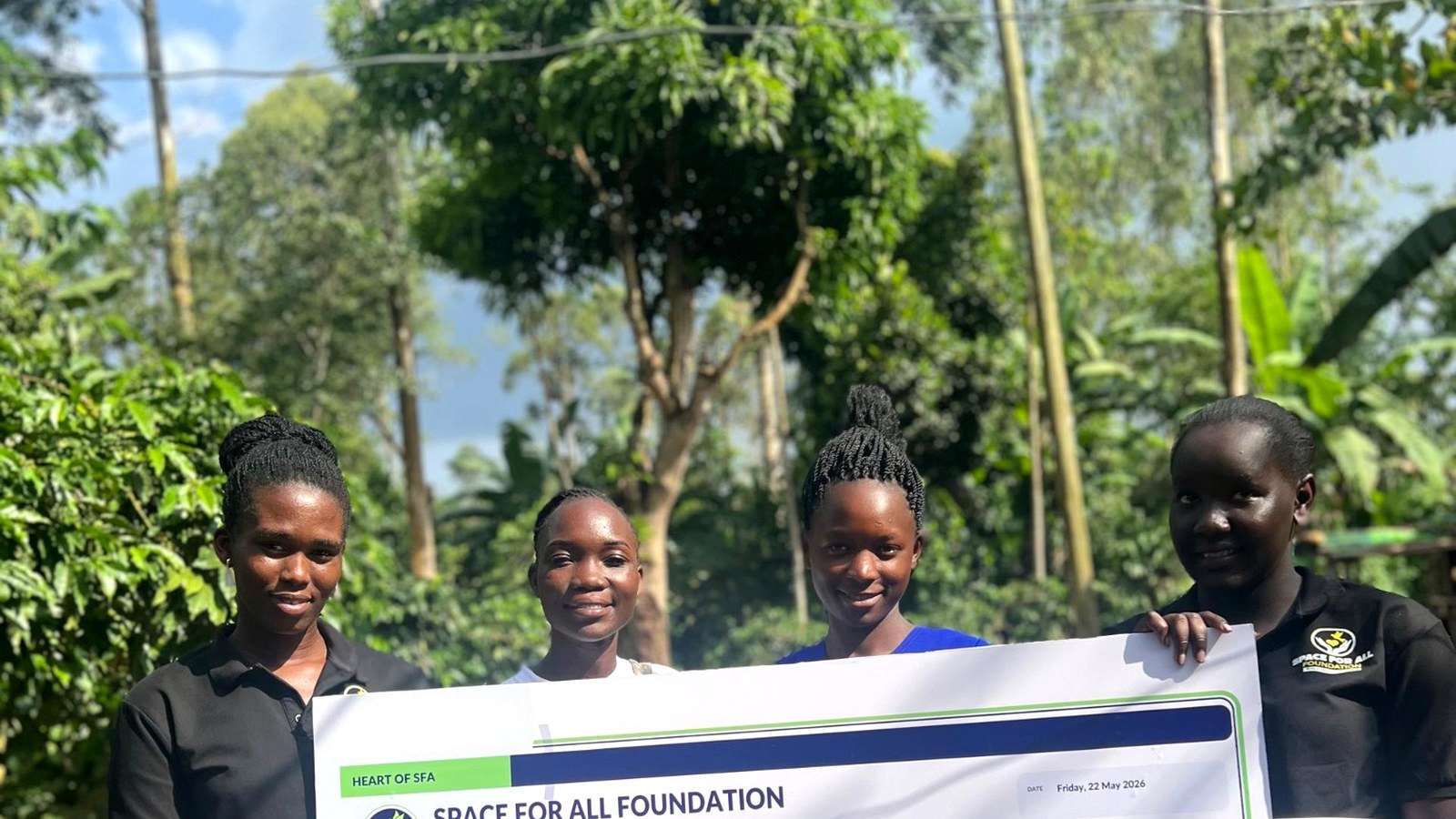 Nabankema Kisakye stands with Space For All Foundation representatives after receiving school fees support in Nkambo Village, Ndejje, Luwero District.